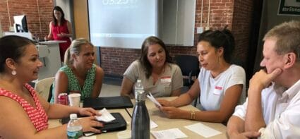 students talking with each other in the table